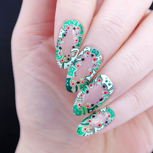 Festive Green Almond Long Press On Nail Set with Colorful Holiday Themed Design