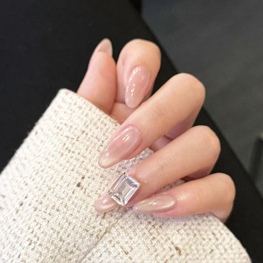 Elegant Charm Long Almond Beige Nails with Stunning Gem Accent