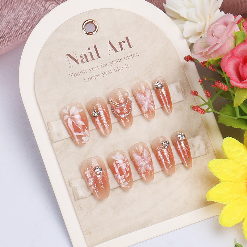 Floral Elegance Medium Almond Peach Press-on Nail Set with Glittering Gems and Artistic Designs