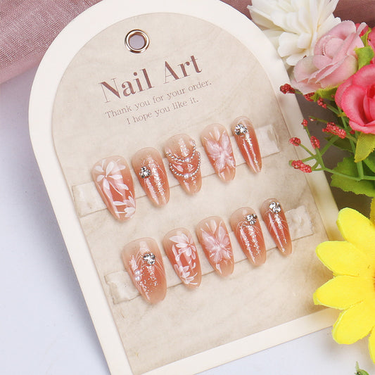 Floral Elegance Medium Almond Peach Press-on Nail Set with Glittering Gems and Artistic Designs