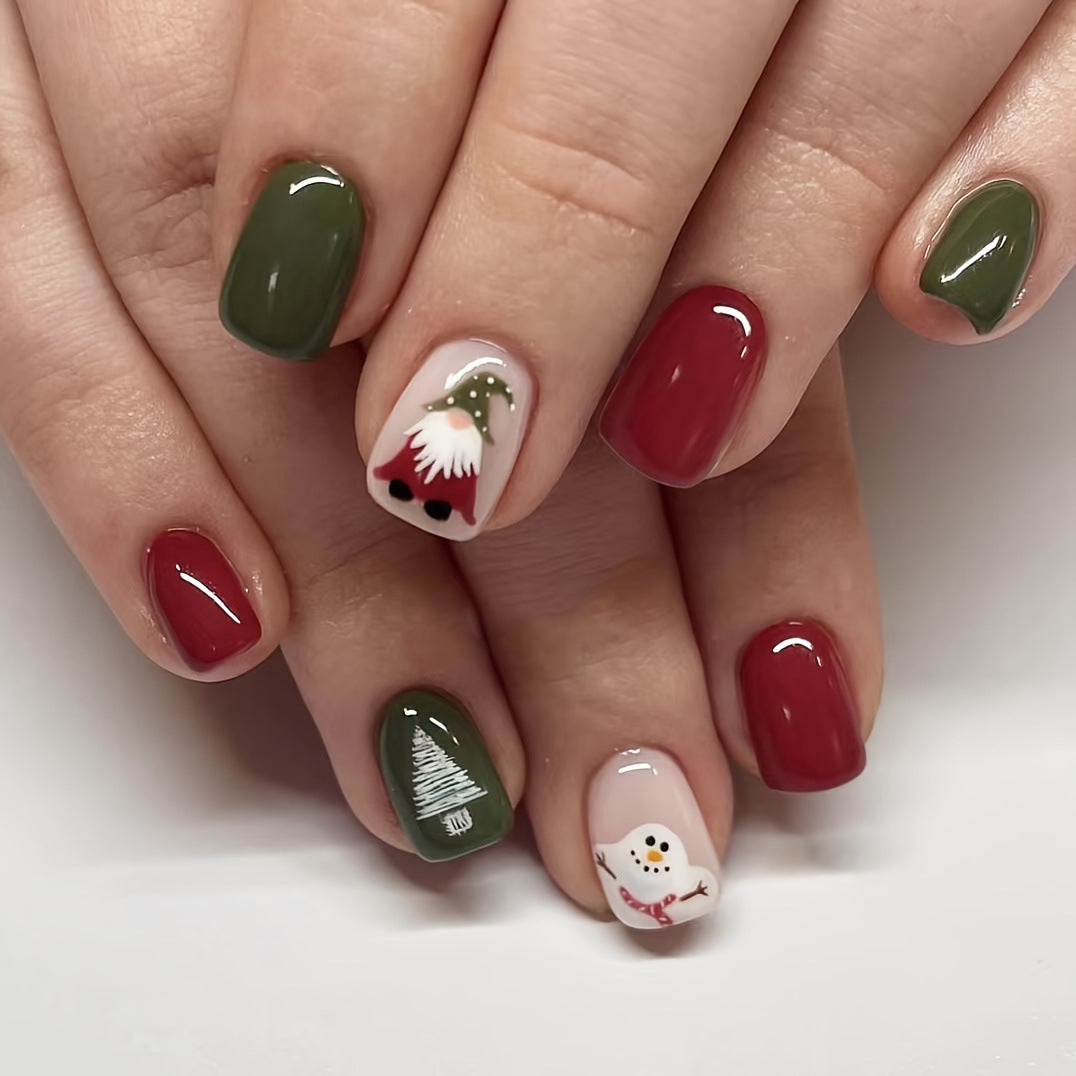 Winter Wonderland Short Length Oval Press On Nails in Green, White, and Red with Festive Snowman and Tree Designs