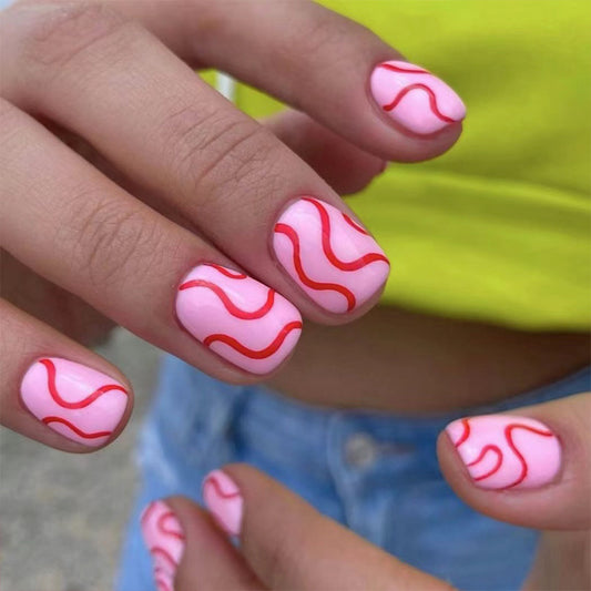 Summer Waves Short Oval Pink Press On Nails with Abstract Red Swirl Accents