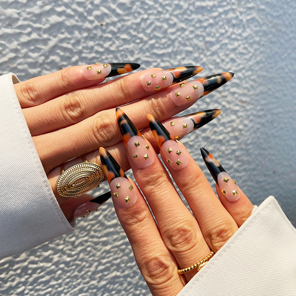 Tortoiseshell Glamor Long Stiletto Press On Nails in Black and Orange with Gold Stud Accents