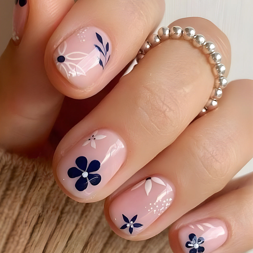 Floral Bliss Short Oval Pink Press on Nail Set with Navy Blue Flower Design and Glossy Finish