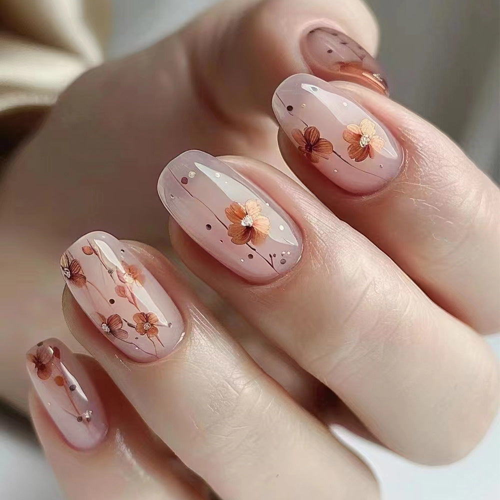 Whimsical Floral Serenity Medium Round Pink Press On Nail Set with Delicate Flower Accents and Sparkling Details