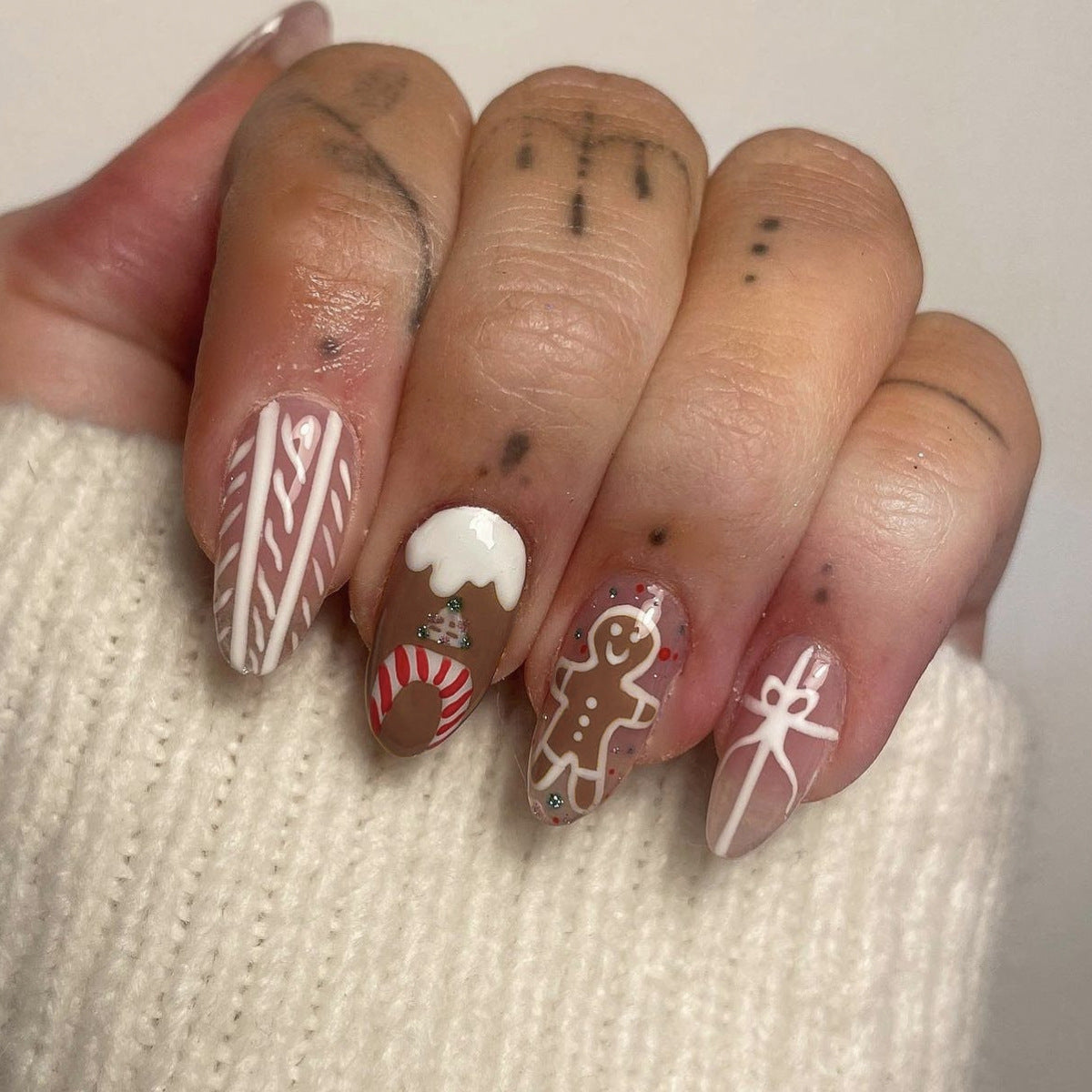 Festive Holiday Charm Medium Almond Beige and Red Press On Nail Set with Unique Gingerbread and Candy Cane Designs