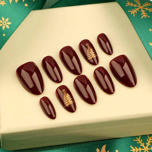 Festive Glamour Medium Oval Burgundy Press On Nail Set with Gold Christmas Tree Design