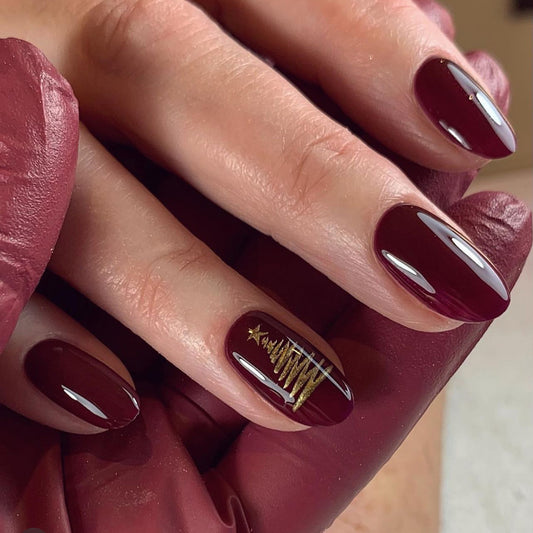 Christmas Glam Medium Oval Deep Burgundy Nails with Gold Tree Design