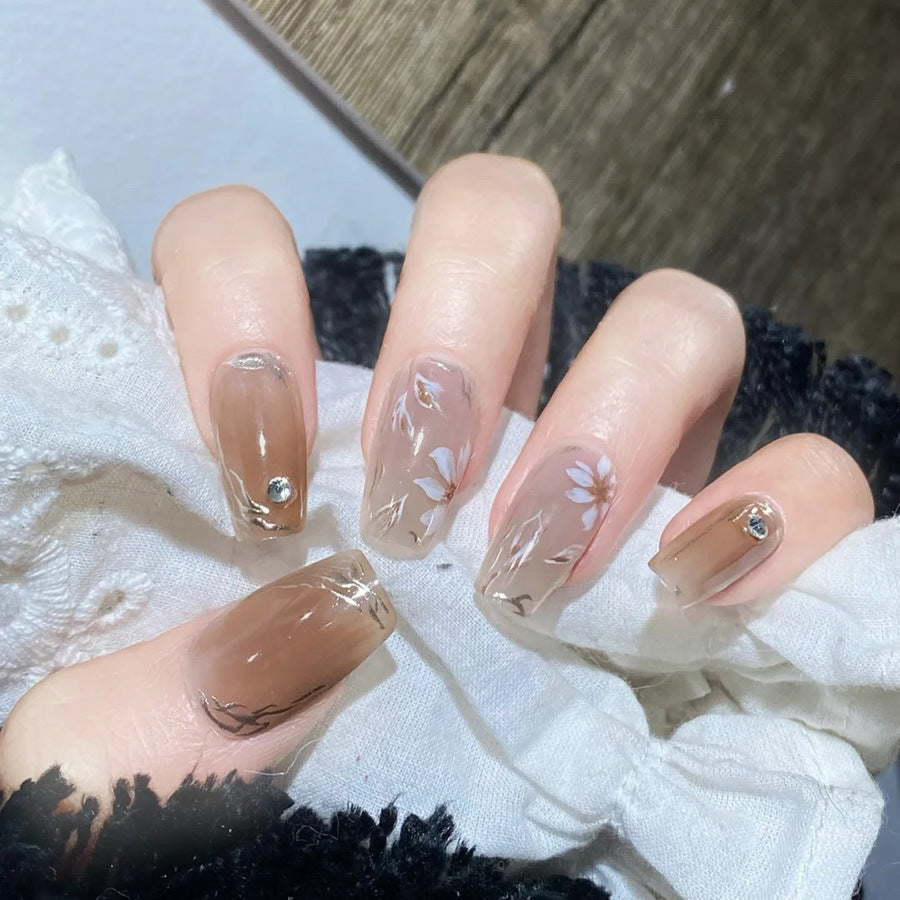 Whimsical Floral Elegance Long Coffin Brown and Beige Press On Nail Set with Delicate Floral Design and Gem Accents