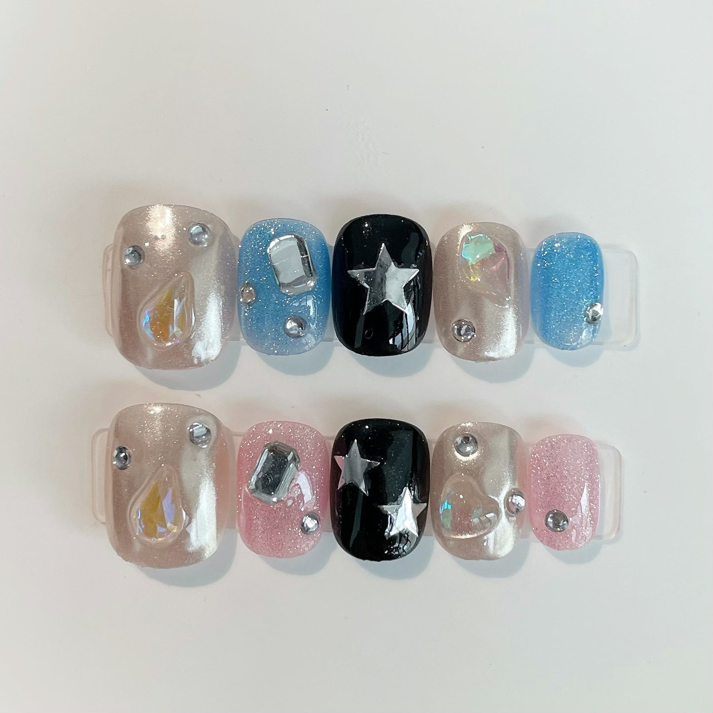 Celestial Dreams Short Round Glittery Press On Nail Set in Pink Blue Black and Silver with Star and Gemstone Accents