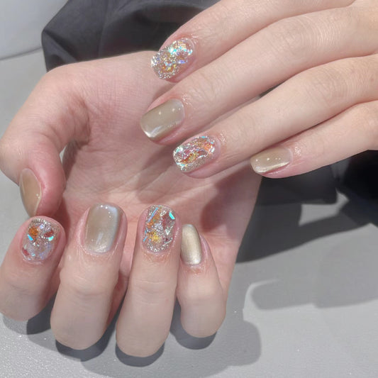 Glamorous Elegance Medium Round Beige Nails with Iridescent Glitter Design