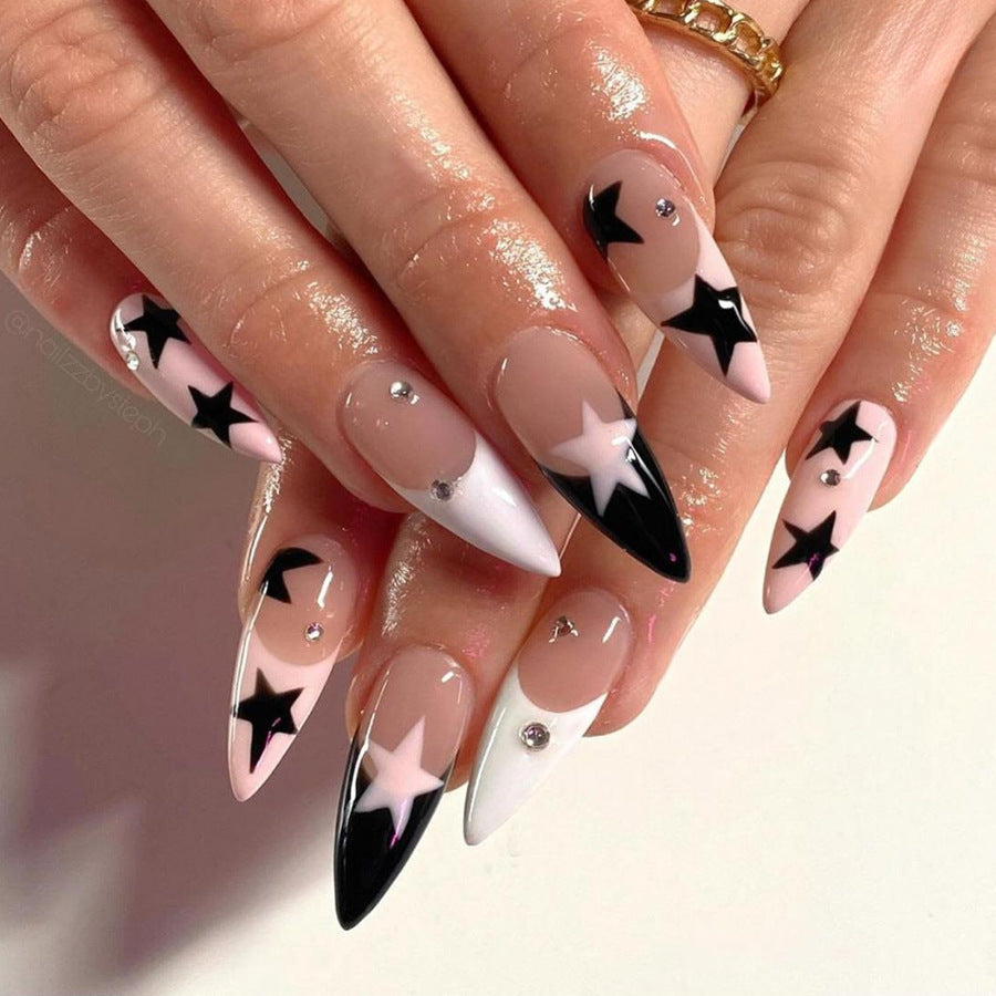 Galactic Glamour Extra Long Stiletto Nail Set in Black, White, and Pink with Star Accents and Rhinestone Embellishments