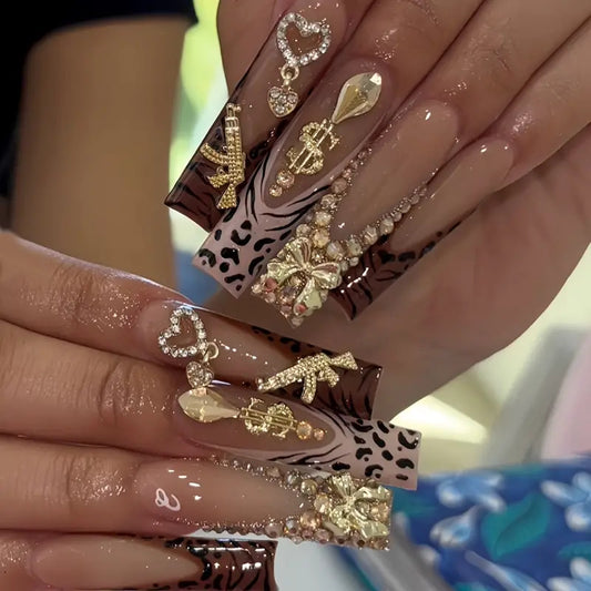 Glamorous Animal Print Long Square Brown Nails with Gold Embellishments and Rhinestone Accents