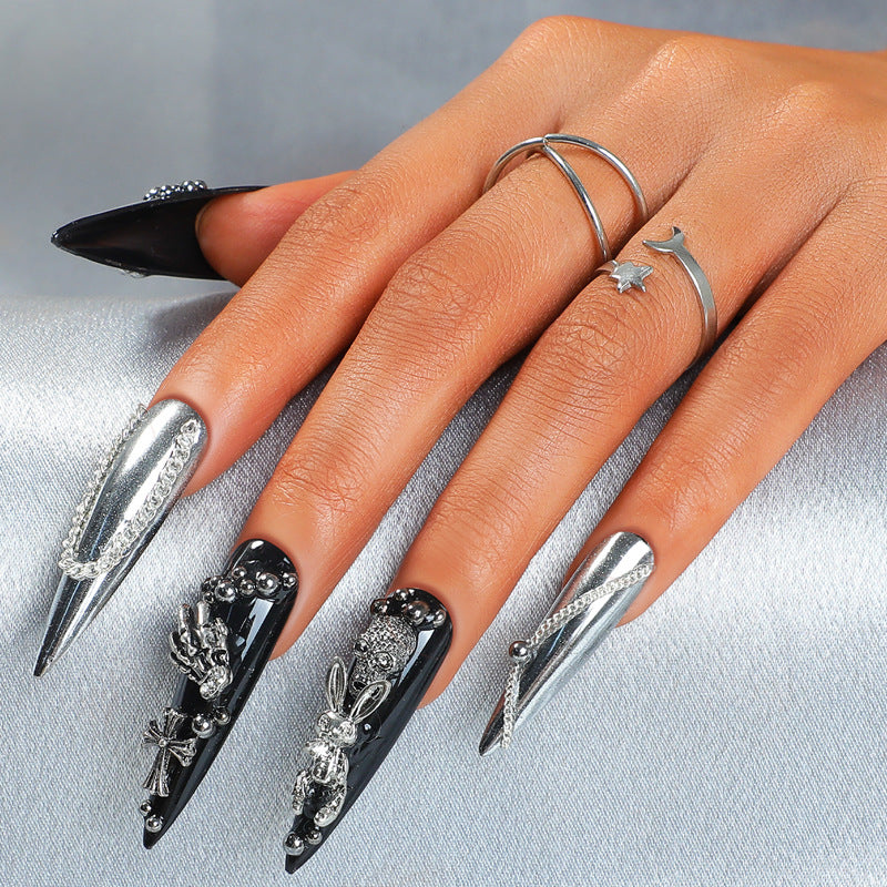 Gothic Elegance long stiletto black and silver press on nail set with intricate detailing and embellishments