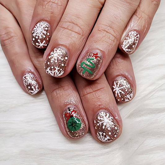 Festive Winter Wonderland Short Oval Gold Glitter Press On Nail Set with Snowflake and Christmas Tree Designs