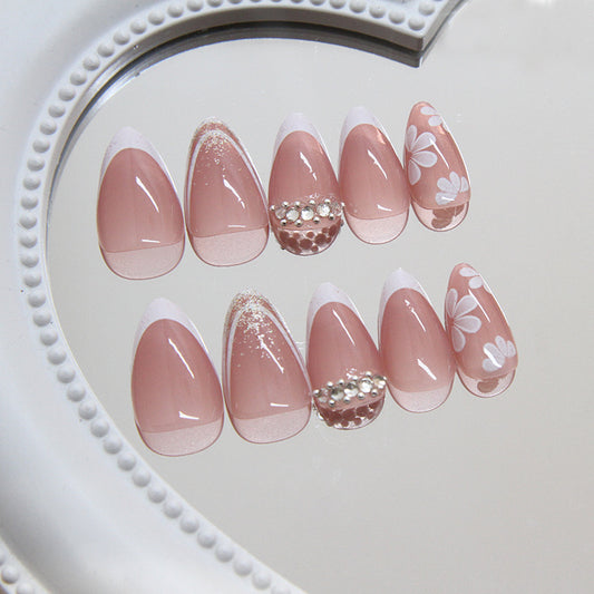 Chic Floral Romance Long Almond Blush Pink Press On Nail Set with Sparkling Accents and White Flower Design