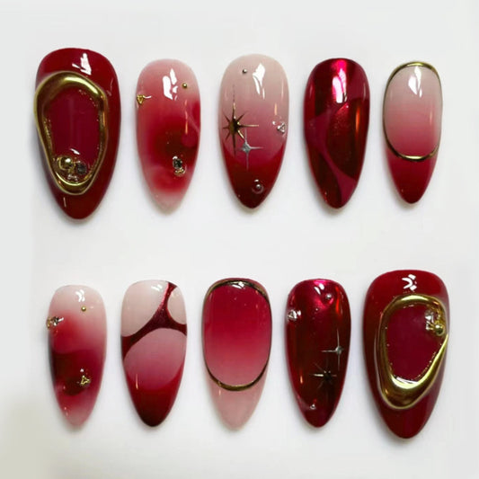 Glamorous Red Elegance Long Almond Shape Ombré Red Nail Set with Gold Accents and Star Detailing