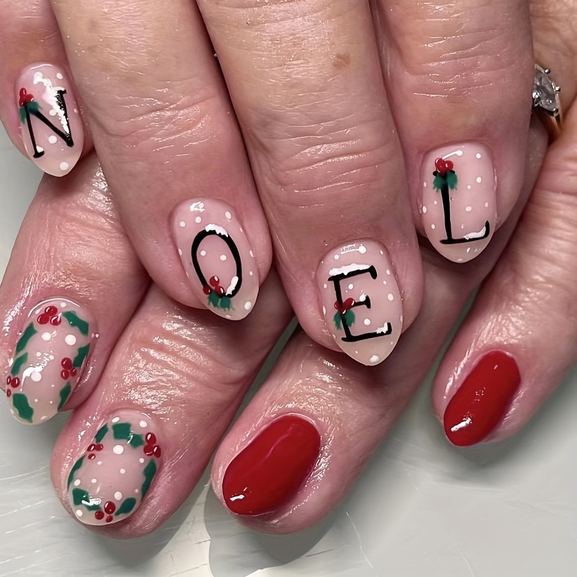 Yuletide Greetings Medium Oval Beige and Red Press On Nail Set with Holly Accents and NOEL Lettering Design