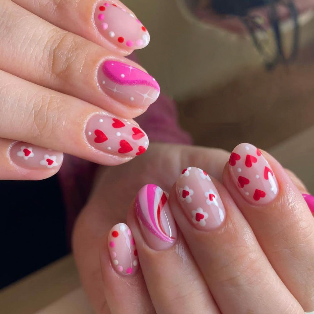 Playful Love Medium Round Sheer Pink Press On Nails with Vibrant Heart Patterns and Candy Stripe Accent