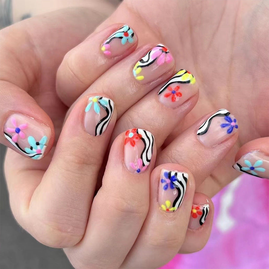 Abstract Artistry Short Squoval Clear Press On Nails with Zebra Stripes and Colorful Floral Accents