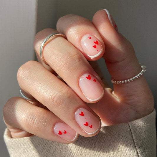 Romantic Short Round Sheer Pink Press-On Nails with Delicate Red Heart Accents for a Lovely Expression