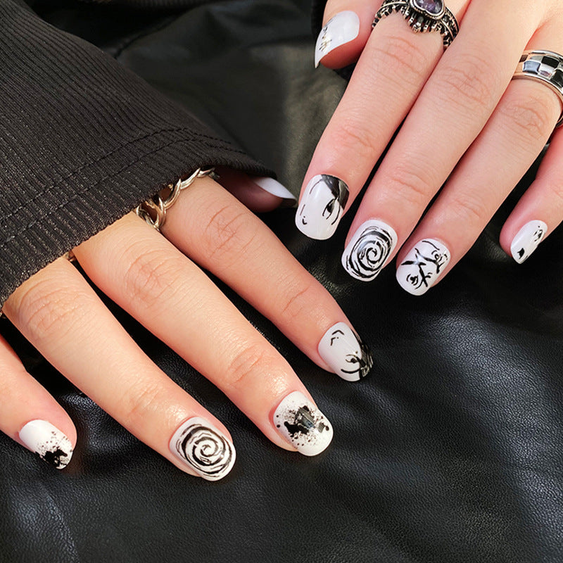 Monochrome Elegance Medium Length Squoval Press On Nail Set in Black and White with Artistic Faces and Abstract Designs