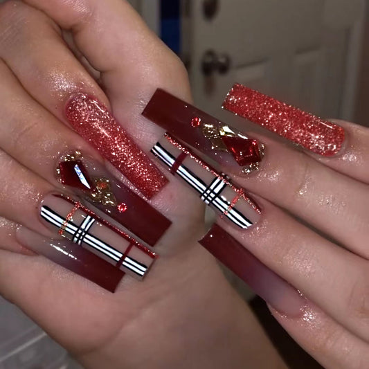 Glamorous Ruby Red Long Coffin Shaped Press On Nail Set with Glitter Accents and Embellishments