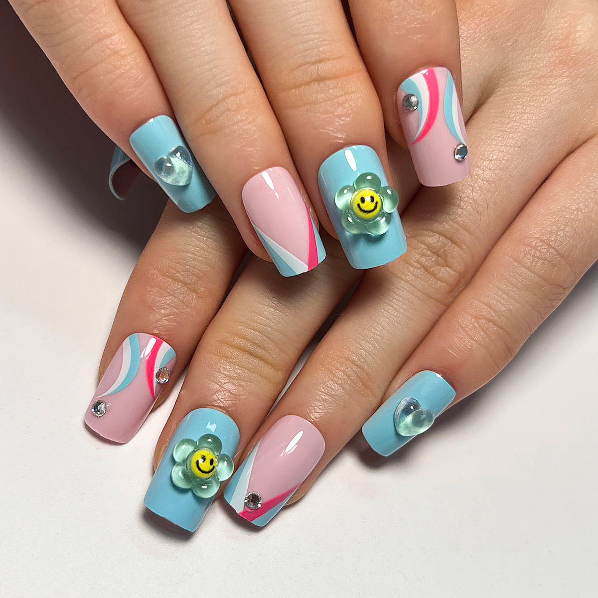 Cheerful Spring Short Square Sky Blue and Pink Press-On Nails with Playful Swirls and Smiley Face Accents