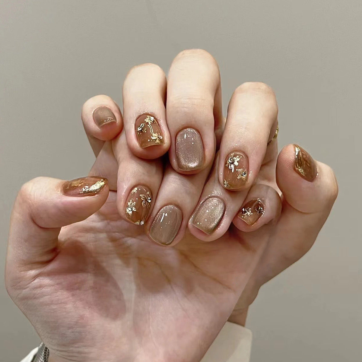 Cateye Gilded Glamour: Medium Oval Taupe Press On Nails with Gold Foil Accents