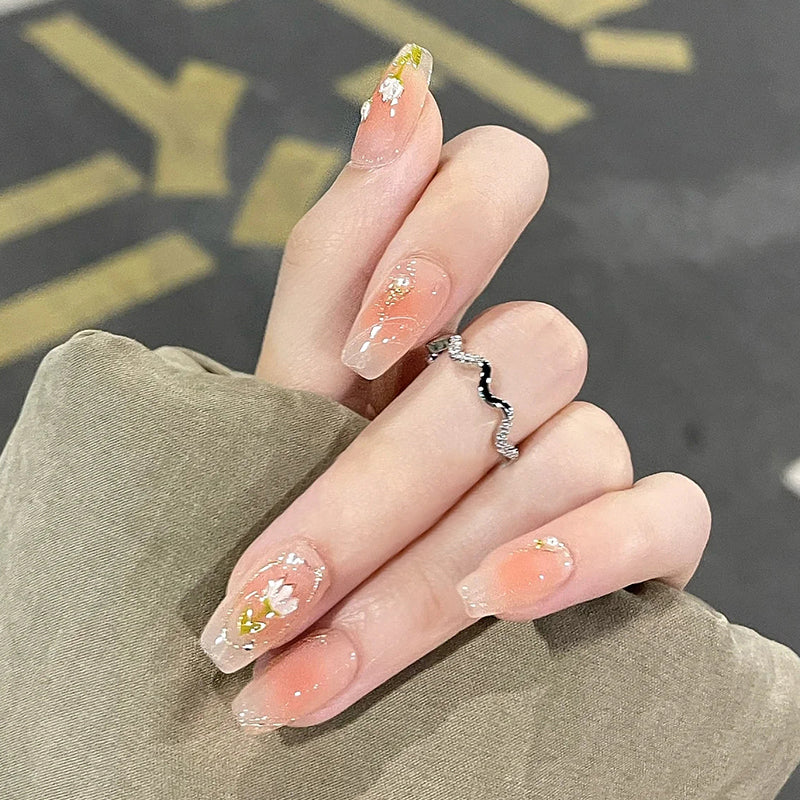 Springtime Blossom Medium Coffin Peach Ombre Press On Nails with Floral Accents and Glitter Highlights