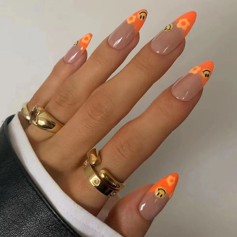 Autumn Whimsy Long Almond Press On Nails Set, Beige Base with Orange French Tips and Smiley Face Accent, Chic Gold Rings Compatible