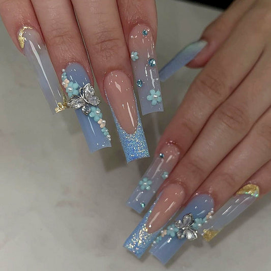 Whimsical Winter Long Square Sky Blue Press-On Nails with Floral Accents and Glitter Gradient