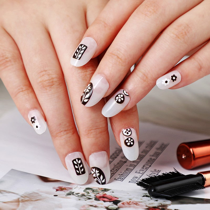 Botanical Bliss Medium Round White Press On Nails with Floral Accents and Unique Black Design Detail