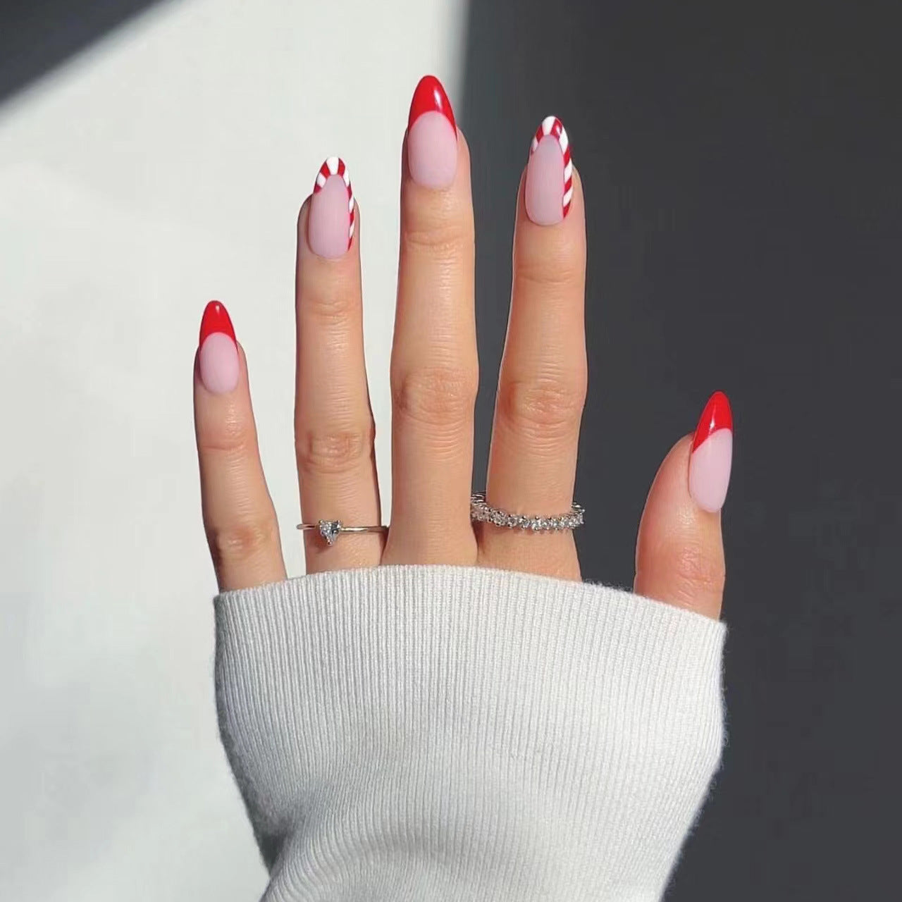 Candy Cane Kisses Long Almond Shaped Press On Nail Set in Red and White with Striped Accent Nails